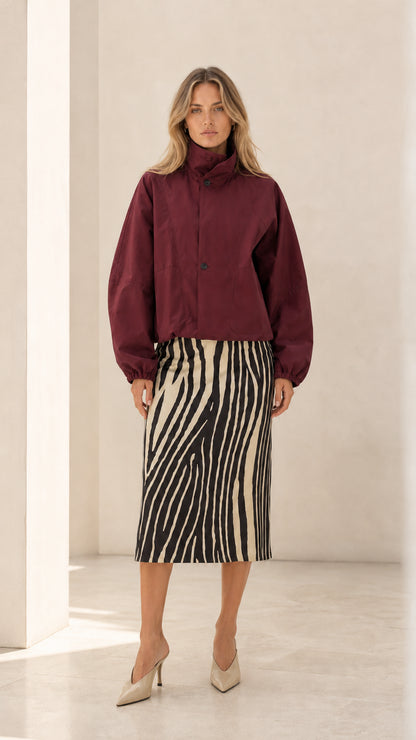 Front view of woman wearing burgundy wine cropped blouson jacket