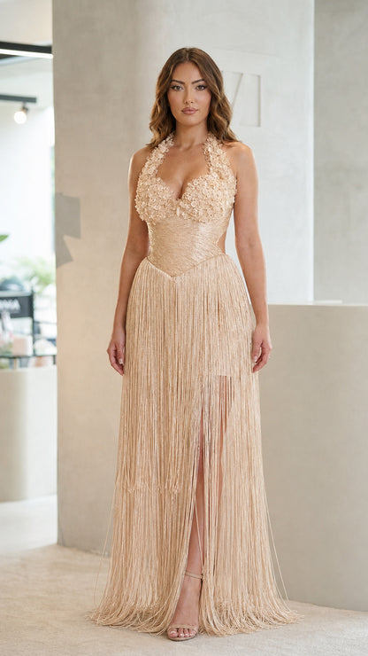 Front view of champagne gold embellished halter fringe formal gown